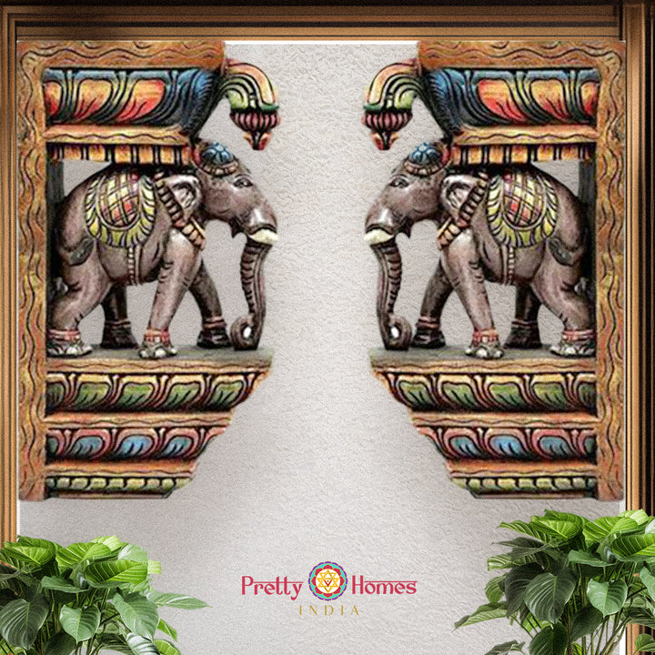 Pair of hand-painted wooden elephant corbels with intricate temple motifs multicolour wall accents.