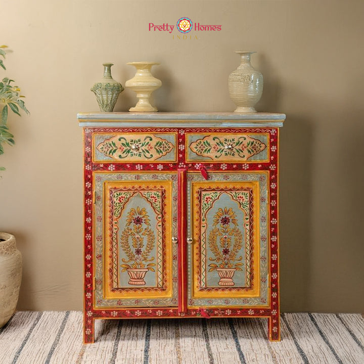 Hand-painted Pichwai sideboard with floral arches and top drawers styled in a home setting.