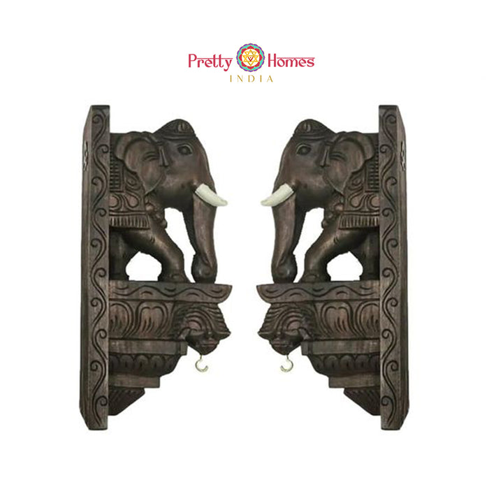Pair of carved wooden elephant corbel brackets in dark wood finish for traditional home decor.