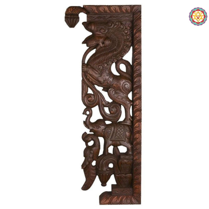 Side profile of wooden Yali entrance bracket showing detailed carving of mythical yali and elephant motif