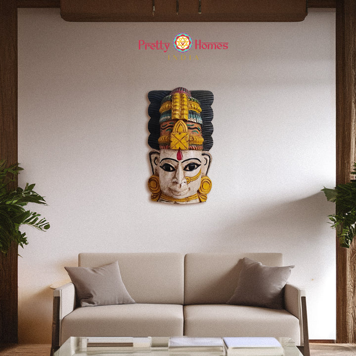 Polychrome carved wooden face mask with tall ornate headdress decorative wall art.