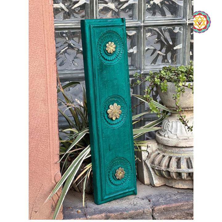 Side view of green mango wood carved panel with floral brass inlay