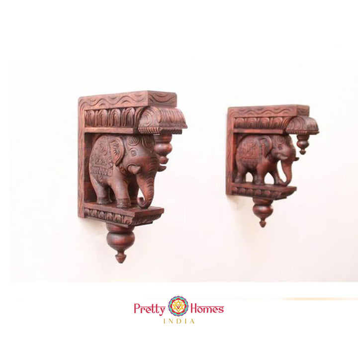 Pair of brown carved wooden elephant wall brackets - Indian-style decorative corbels.