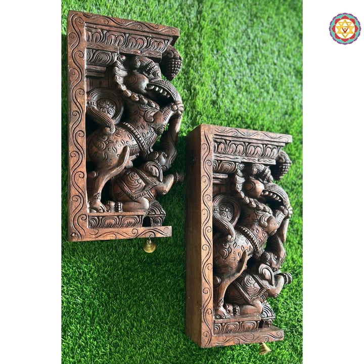 Side profile of wooden Yali bracket showing elephant trunk detail and ornate floral carvings