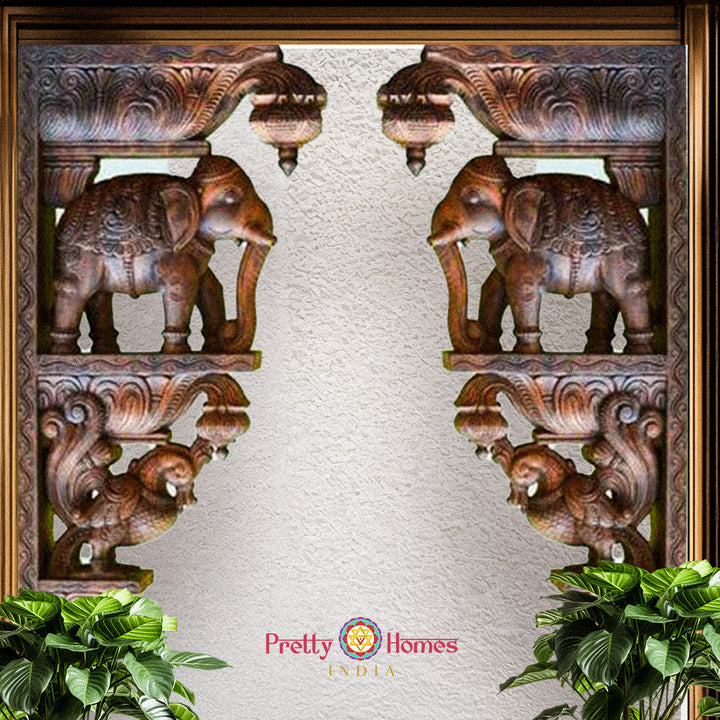 Ornate framed display of carved elephant corbels with elaborate pedestal carving.
