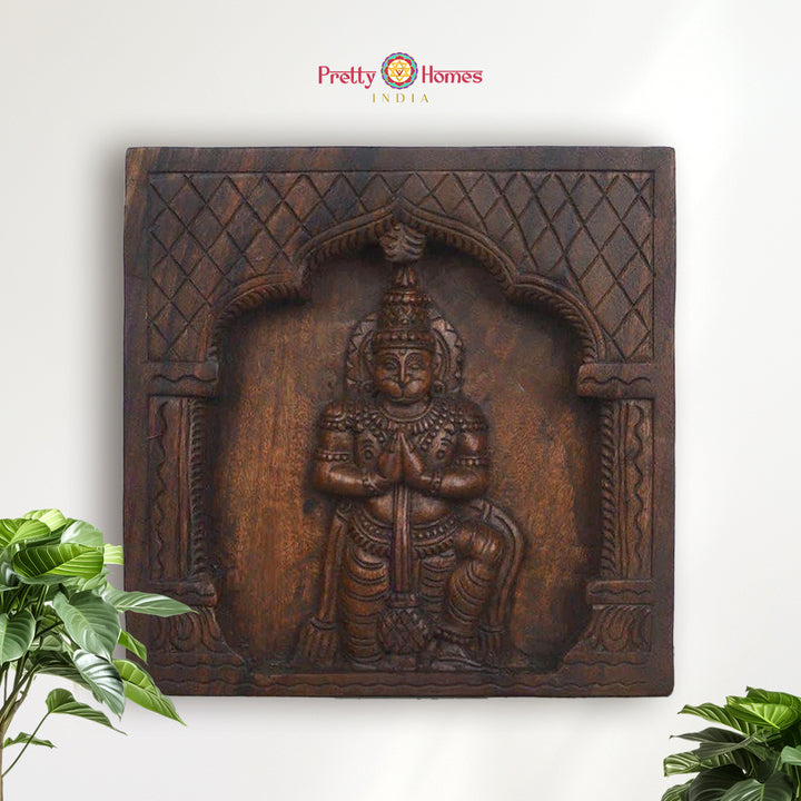 Handcarved wooden panel showing Lord Hanuman in kneeling pose