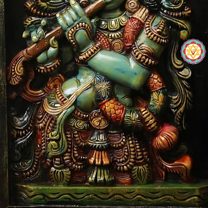 Front view of wooden Krishna handcarved frame — detailed deity carving with peacock and flute motifs, antique polish finish