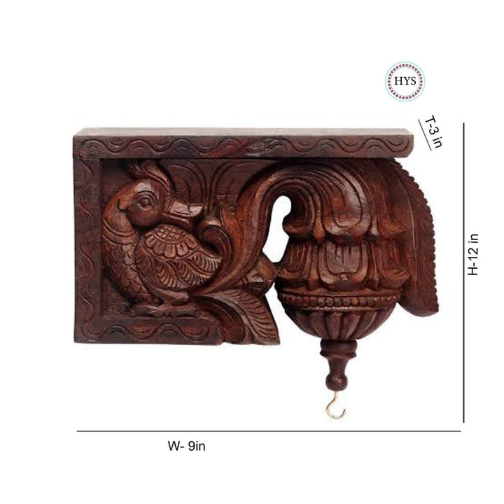 Ornate hand-carved wooden corbel bracket with scrollwork and hanging hook.