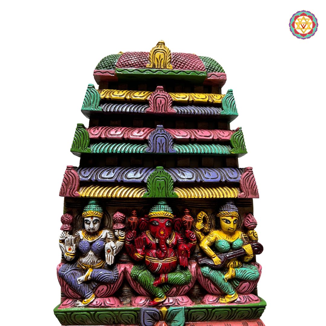 Front view of Ganesha Laxmi Saraswati wooden panel — intricate prabhavali frame and deity carvings, antique brown polish