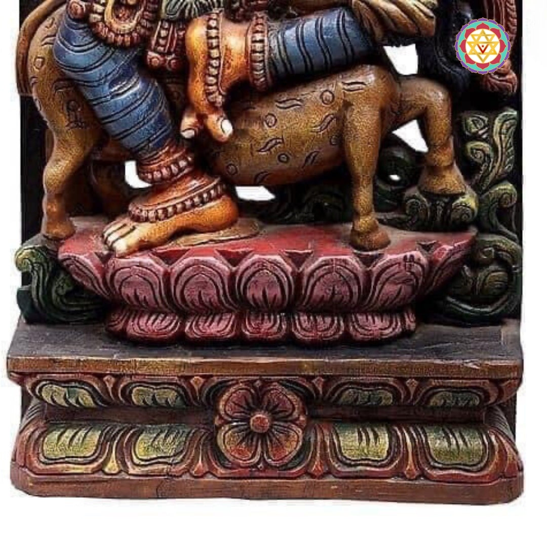 Detailed view of dancing Apsara showing high hair bun and intricate lotus base carvings