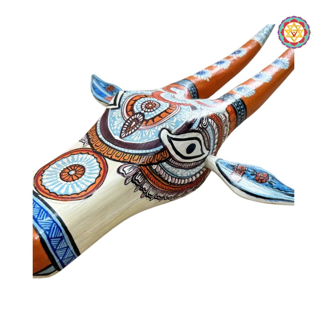 angled view of orange and blue cow head wall mount showing painted horns and expressive features