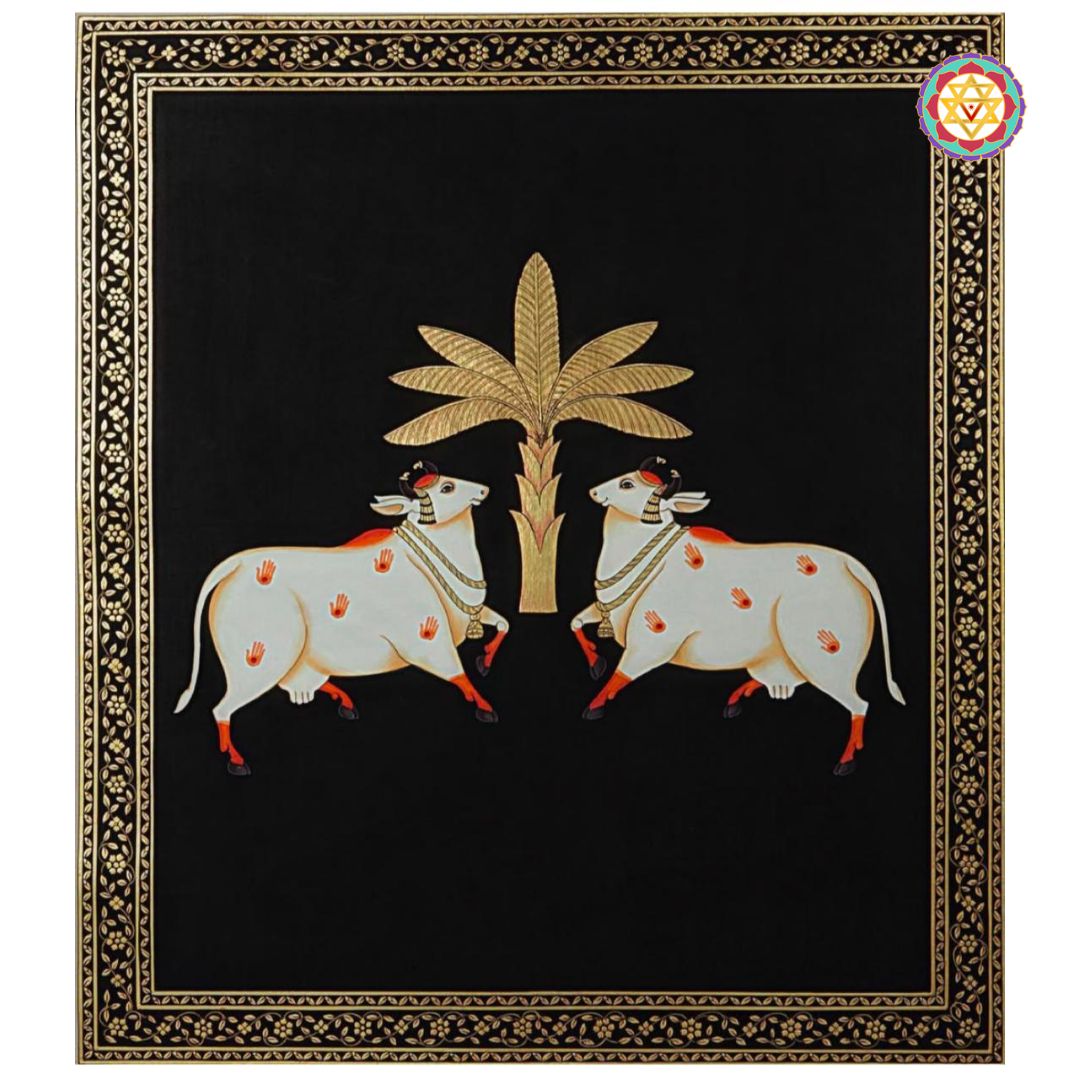 Close-up of pichwai painting with pair of sacred cows and gold tree on deep black canvas.