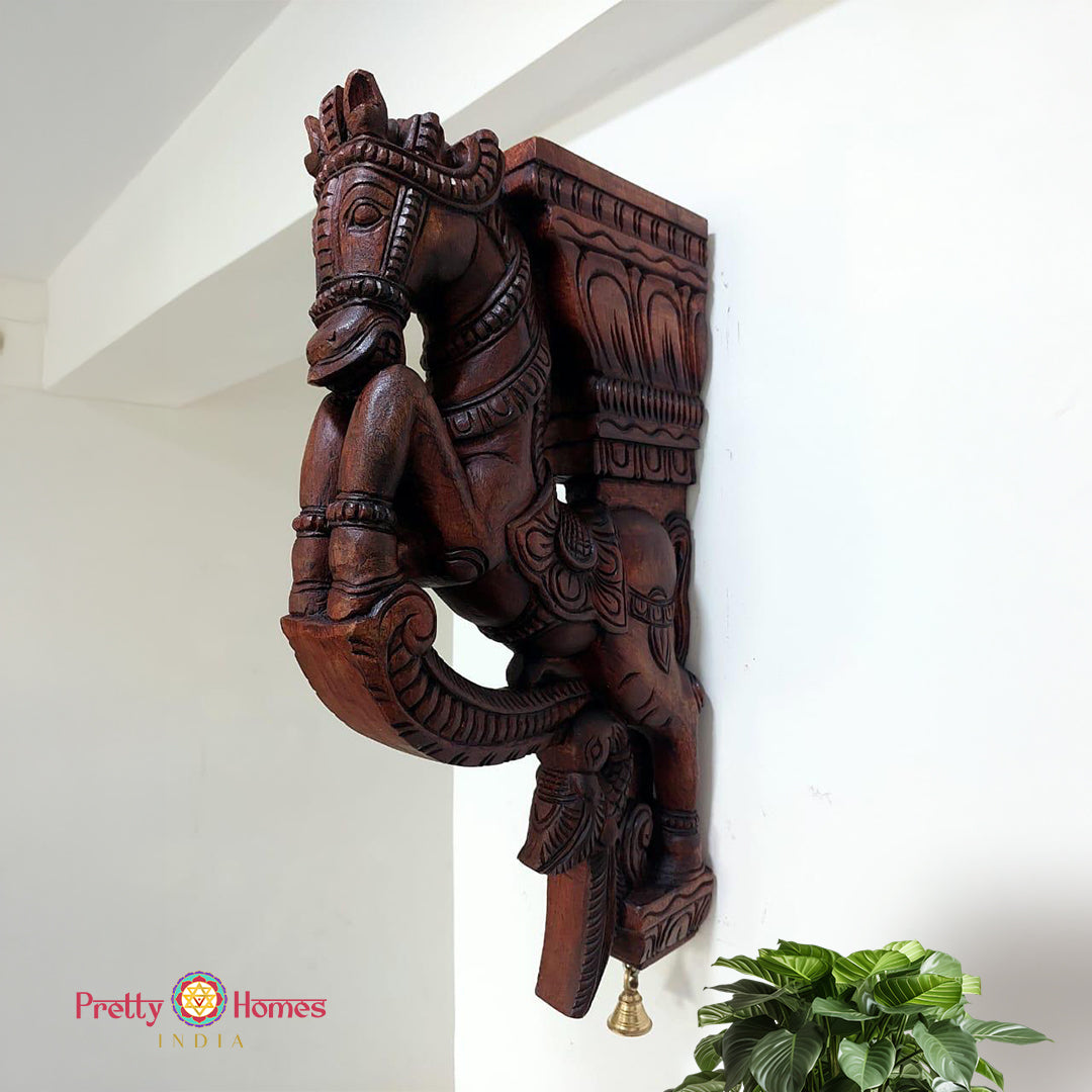 Front view of wooden horse wall brackets showing peacock annam carvings and floral detailing