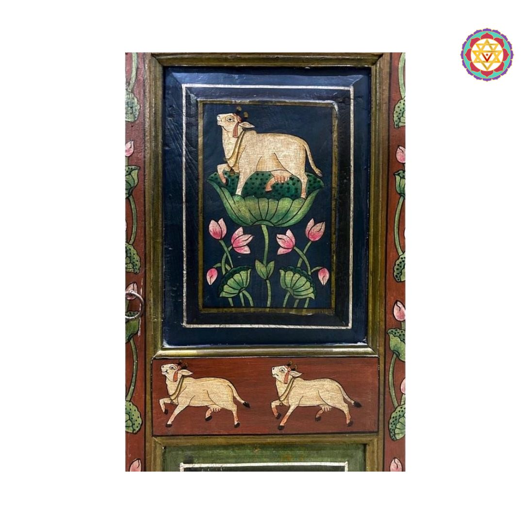 side view of pichwai style artwork on painted wooden cabinet
