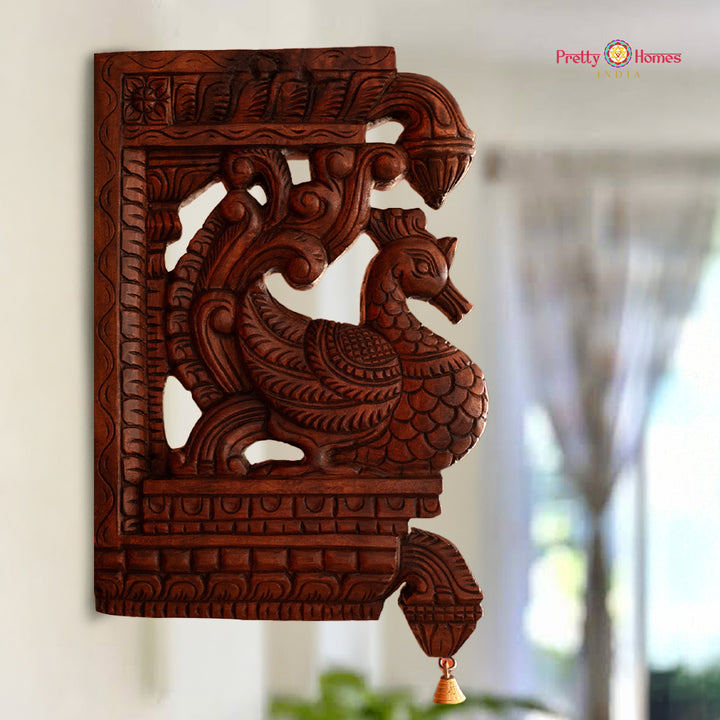 Carved wooden bracket panel with Annapakshi bird and hanging bell