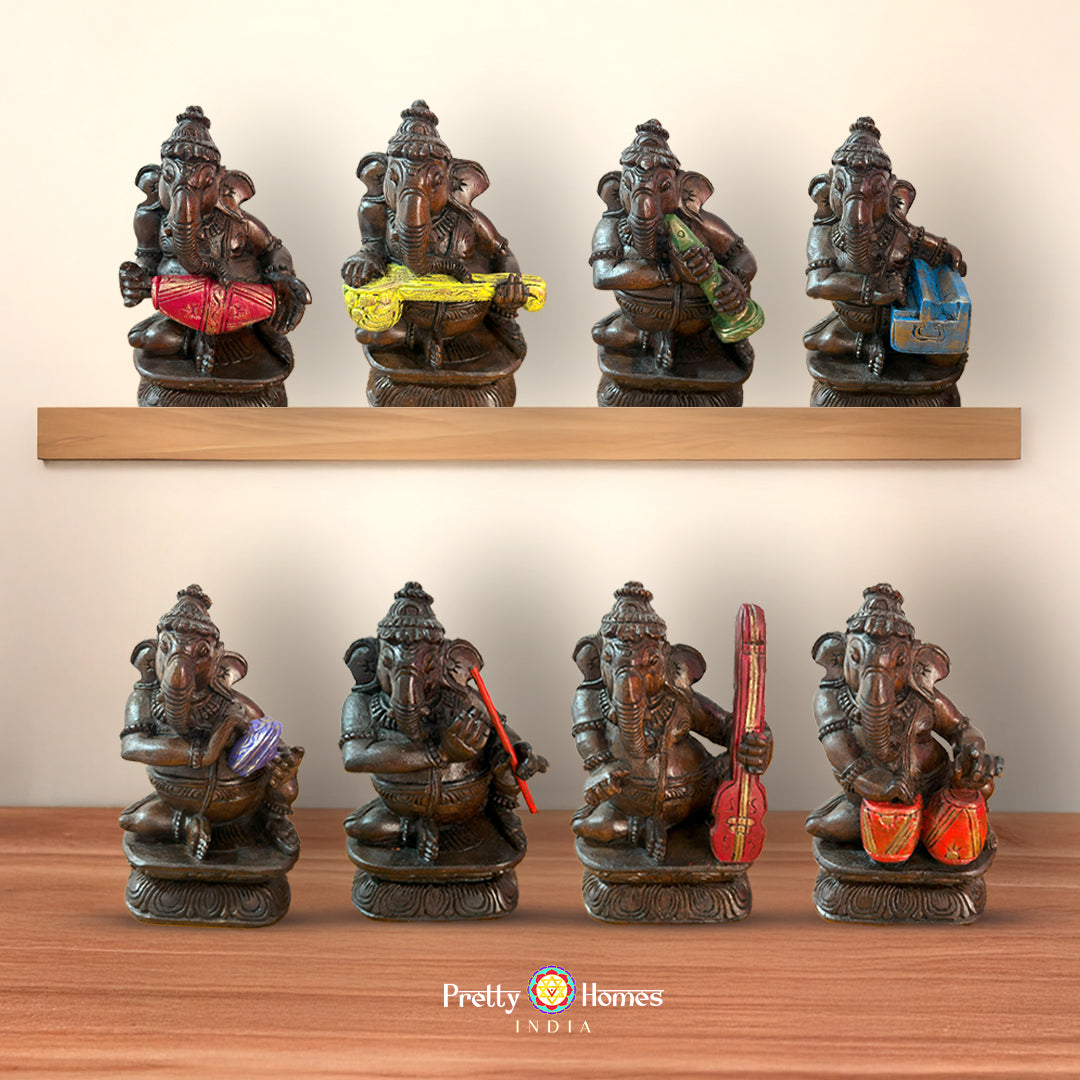 Set of Lord Ganesh figurines holding different musical instruments hand-painted in wood