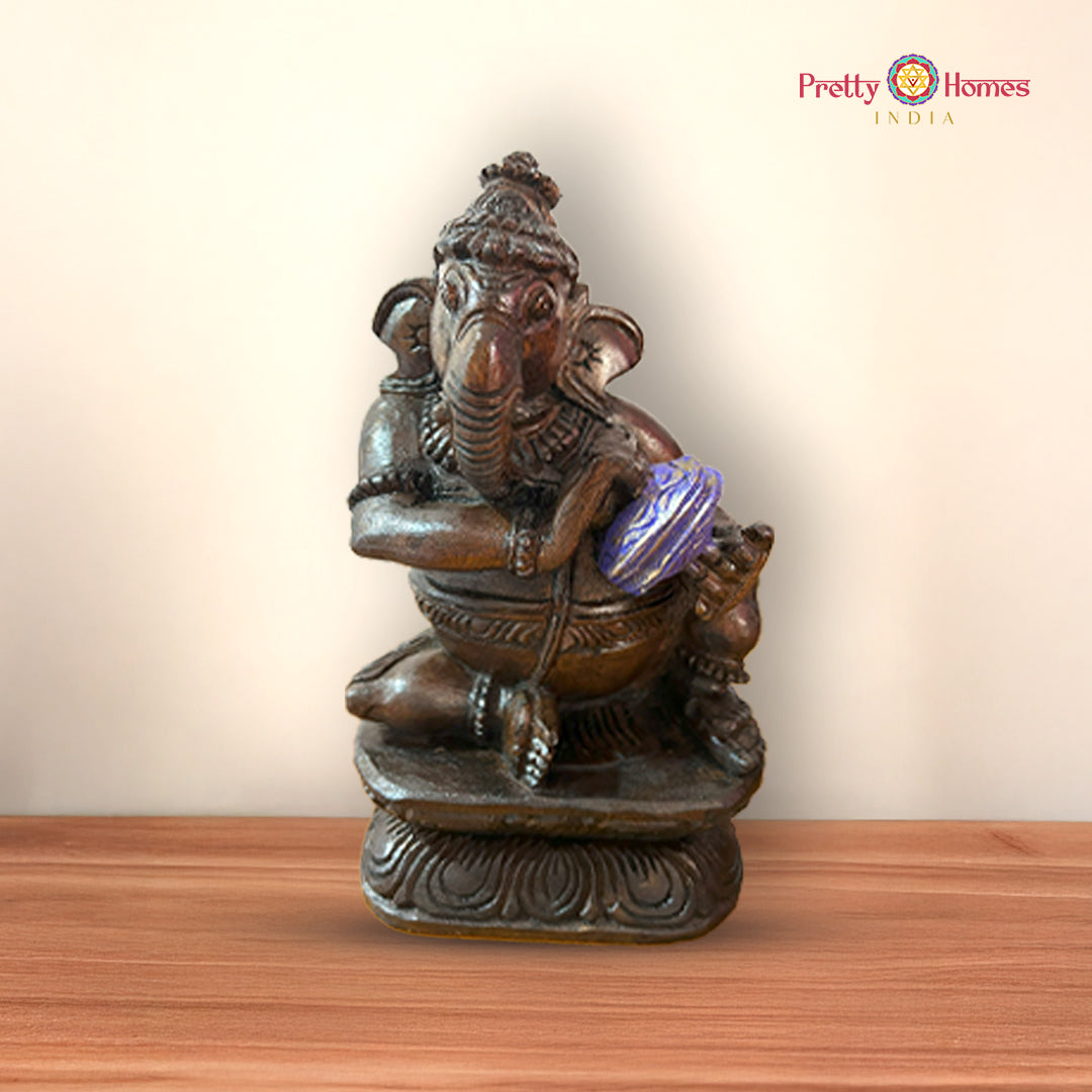Single Ganesh idol playing sitar crafted from wood and hand-painted in vibrant tones