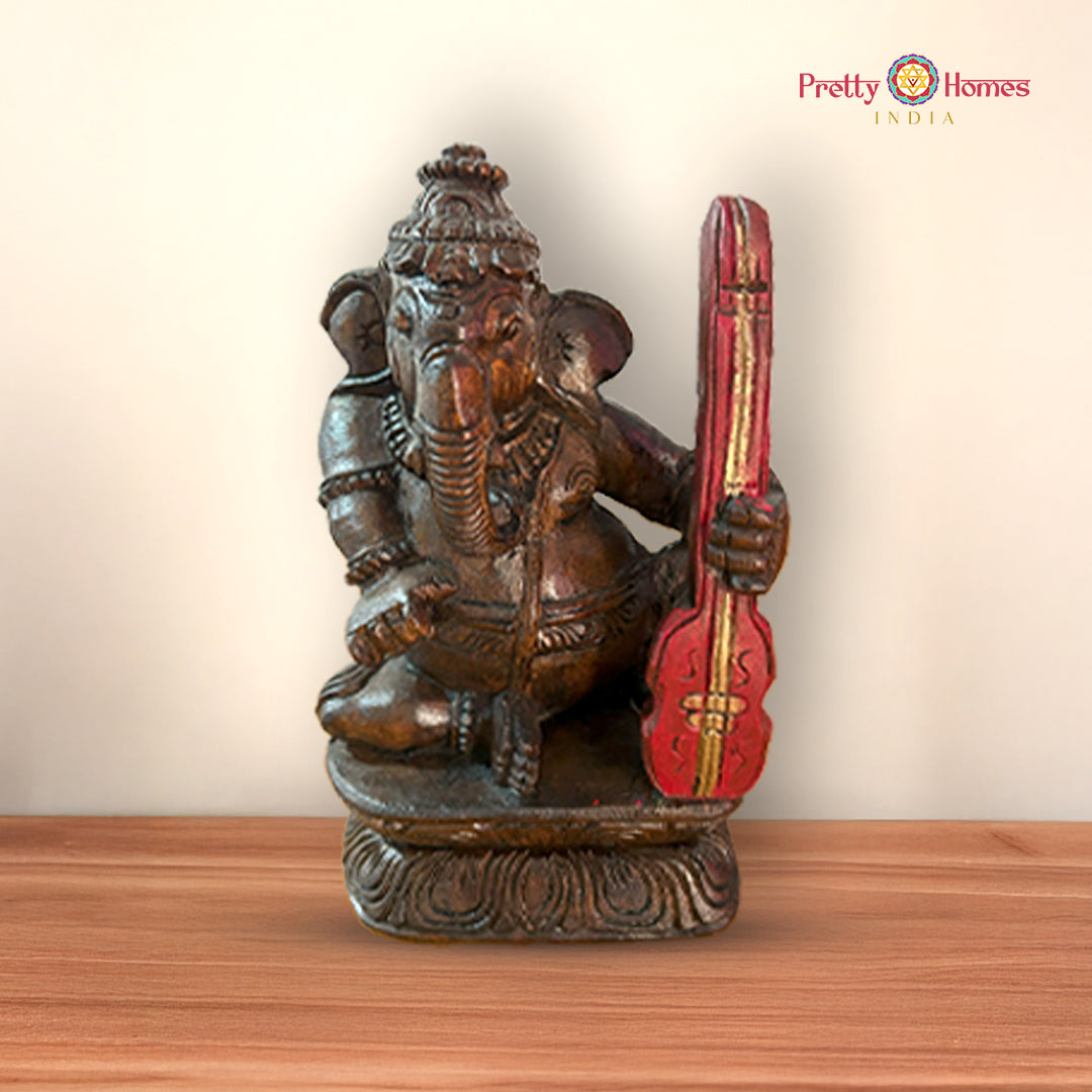 Wooden Ganesh statue playing mridangam symbolizing music and celebration