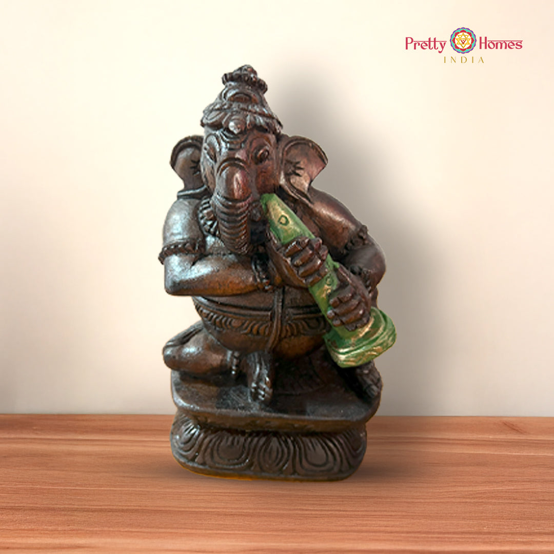 Set of musical Ganesh idols displayed together on a wooden surface