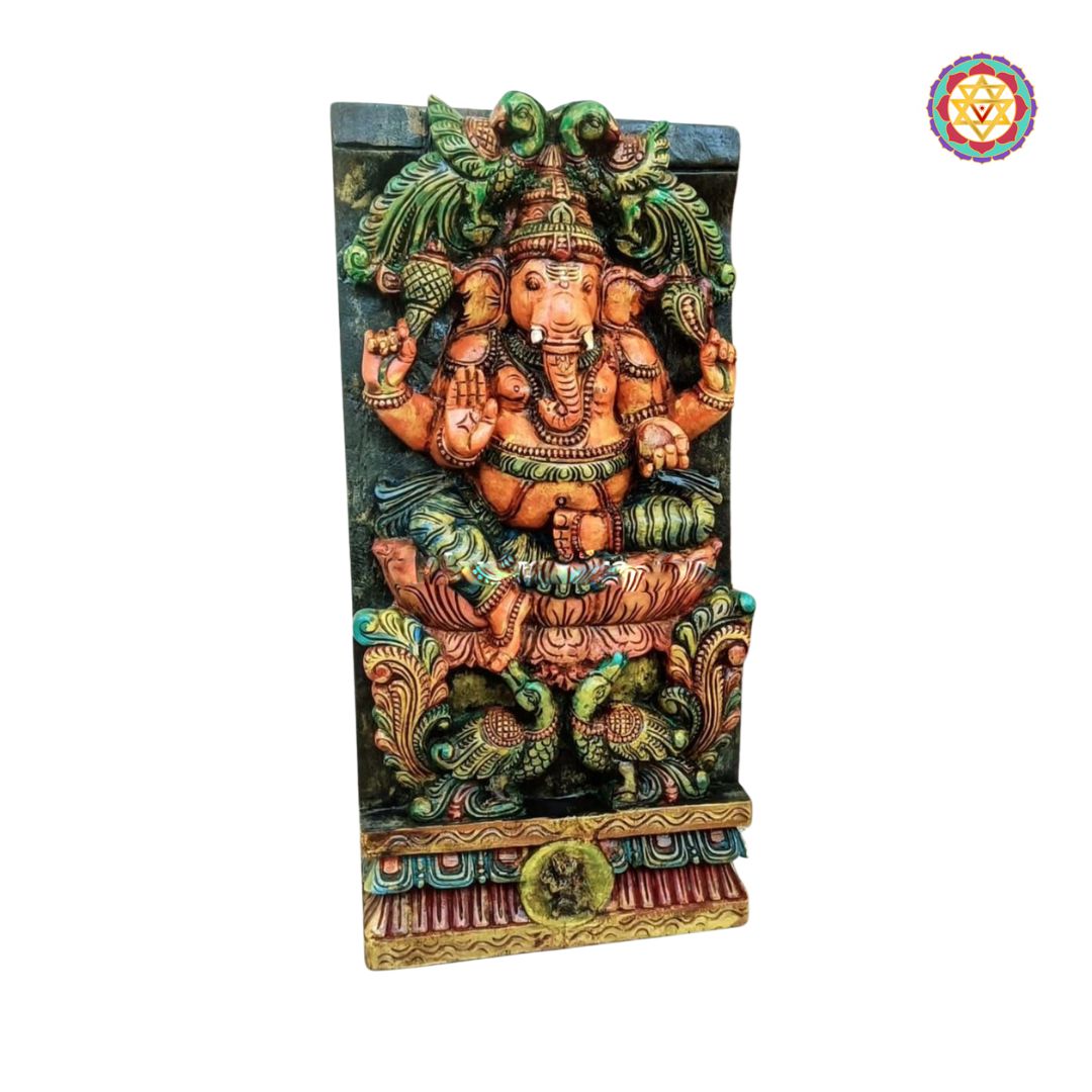 Decorative wall art with a colorful depiction of a deity on a white background - Side view of handcarved Ganesha panel in multicolour