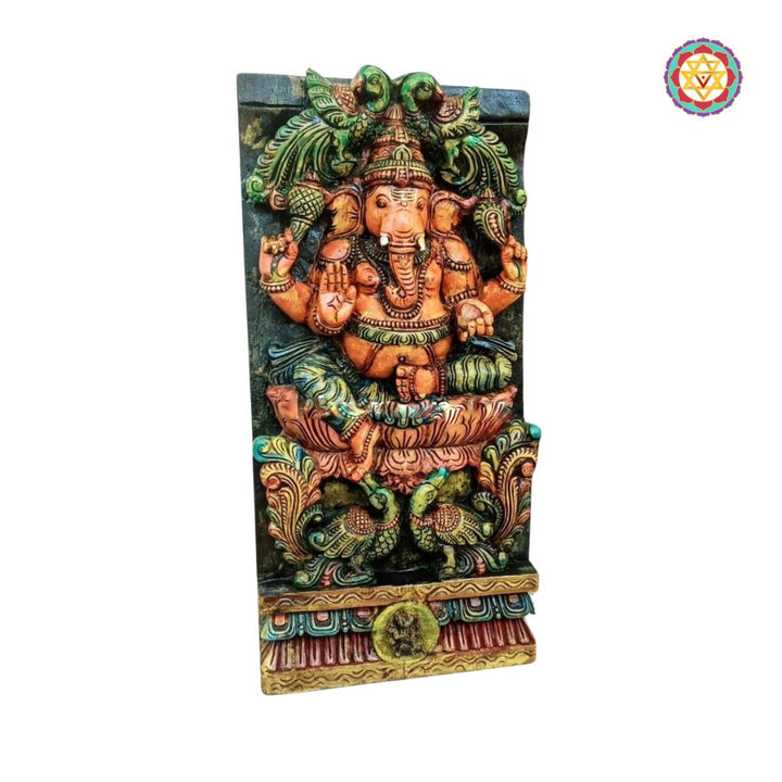 Decorative wall art with a colorful depiction of a deity on a white background - Side view of handcarved Ganesha panel in multicolour