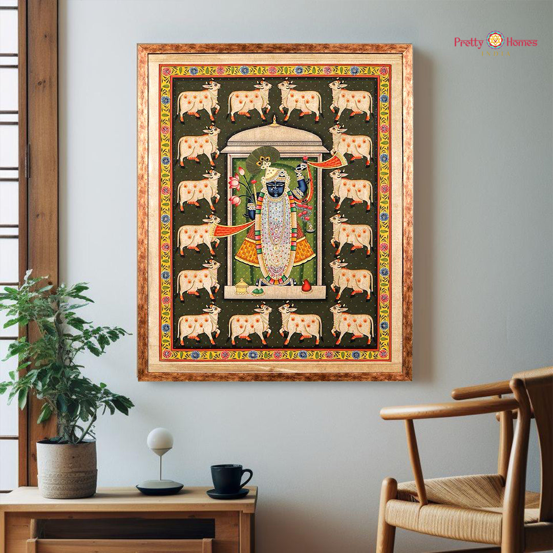 Framed hand-painted Shreenathji Pichwai painting with pichwai cows on dark green background – a classic for pichwai home decor.