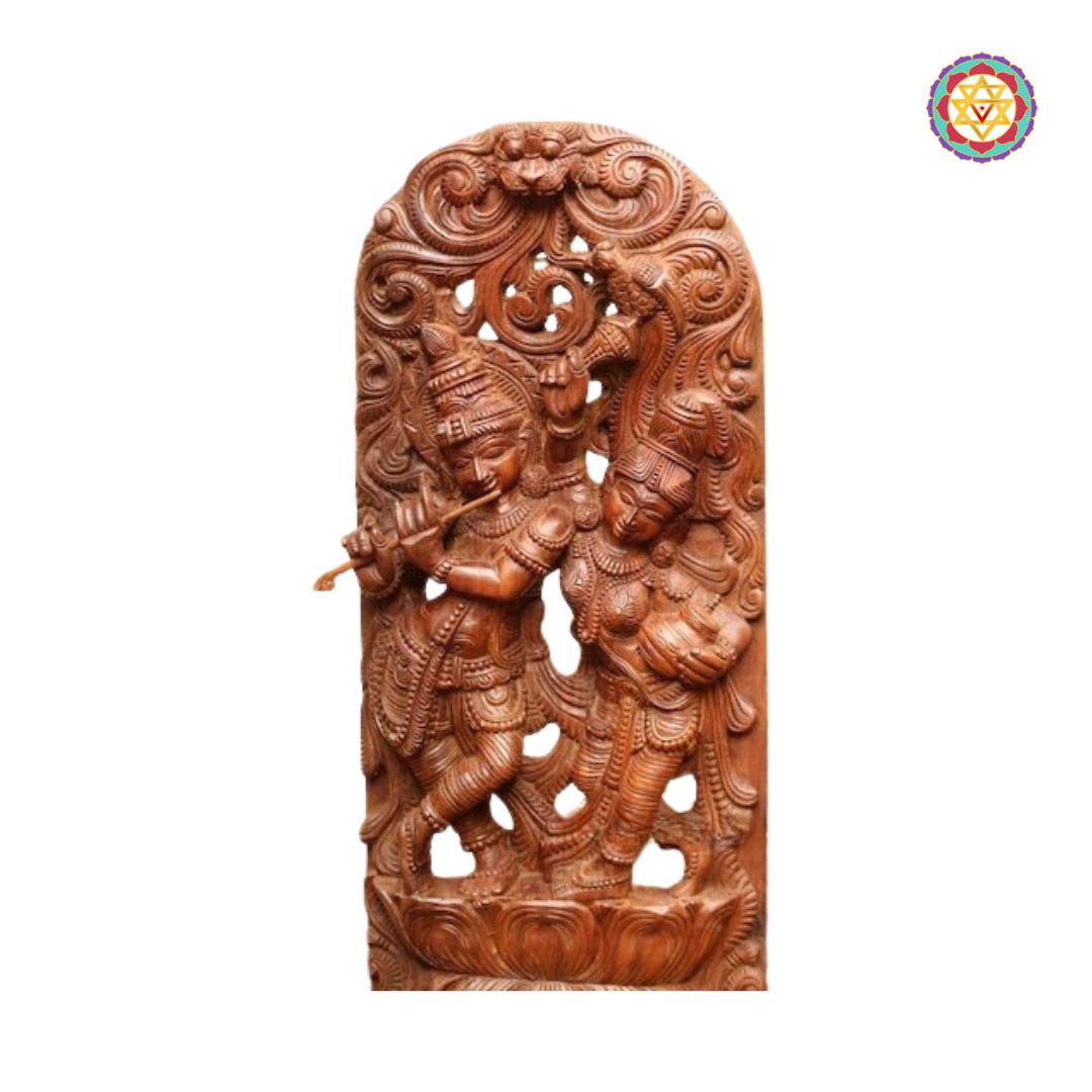 close up of krishna with flute and radha under carved wooden canopy