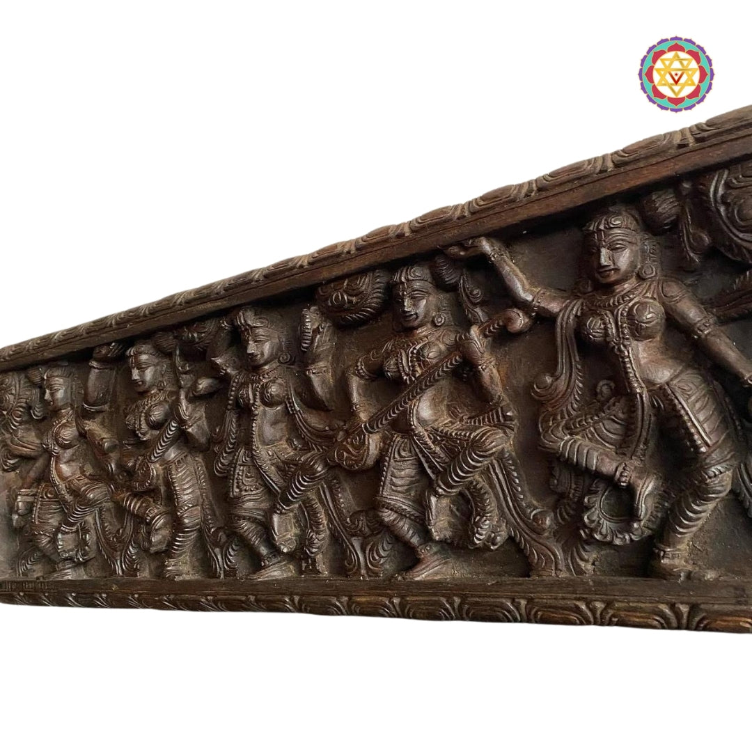 Close-up of Apsara playing mridangam in wooden carving