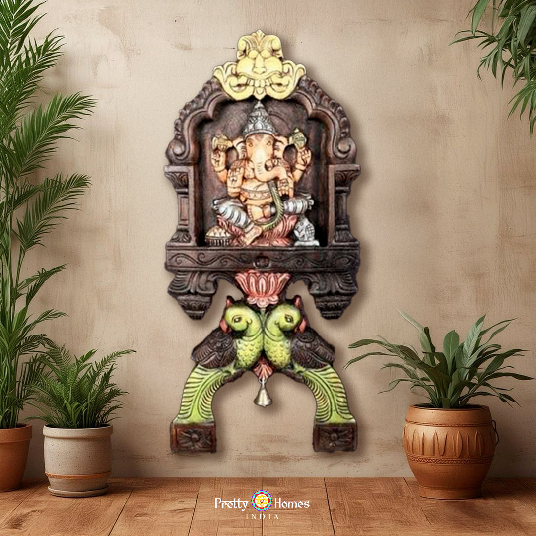 Woodcarved Ganesha & Laxmi kavadi style wall mounts with parrot carvings .