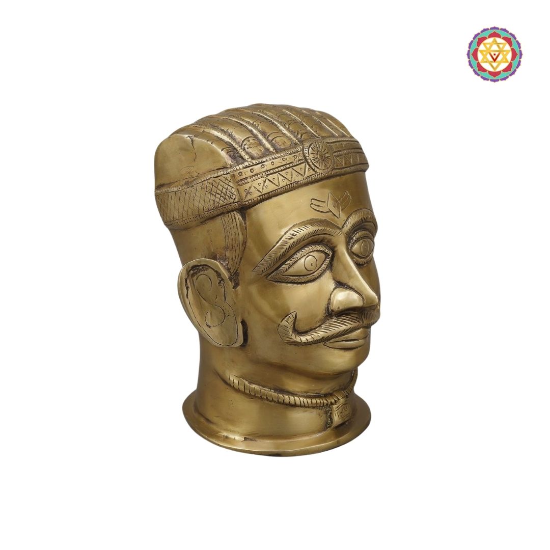 side view of brass Shiva face sculpture showing refined facial features