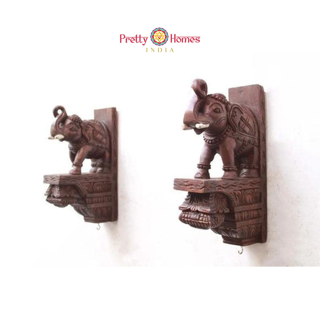 Pair of small carved wooden elephant corbels with hooks - decorative wall accents.