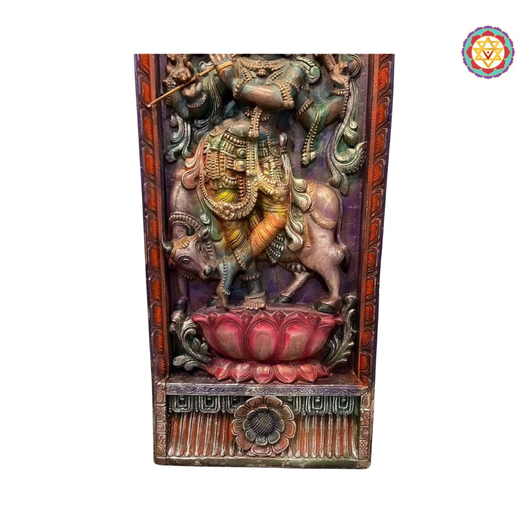 Decorative wall panel with a figure on a bull, colorful and detailed, on a white background. Side view of carved Cow Krishna panel with intricate detailing

