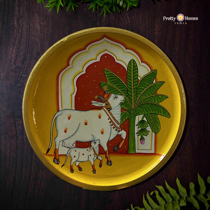 Yellow cow pichwai wall plate with traditional mehrab patterns