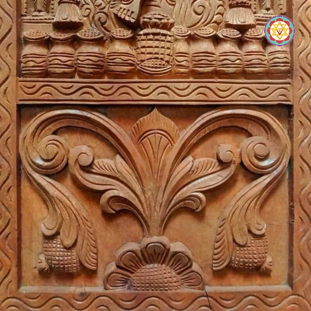 close-up of lord kubera face carving in antique wood polish