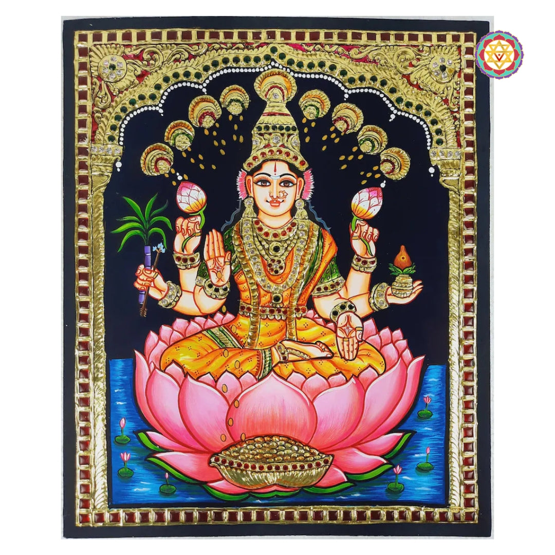 “Tanjore painting of Goddess Lakshmi seated on pink lotus, surrounded by ornate golden arch and sacred backdrop”