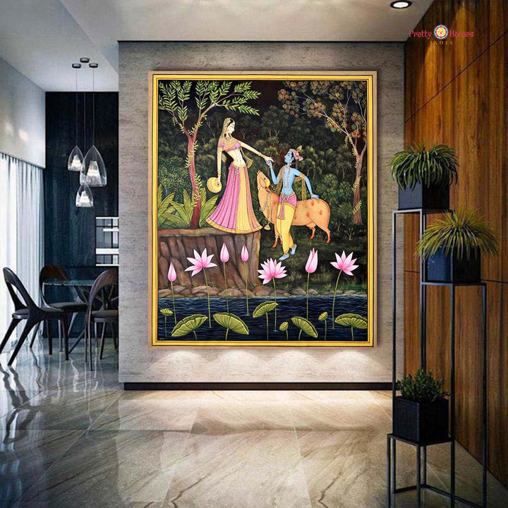 Hand-painted pichwai painting of Krishna and Radha in forest, displayed in modern interior.
