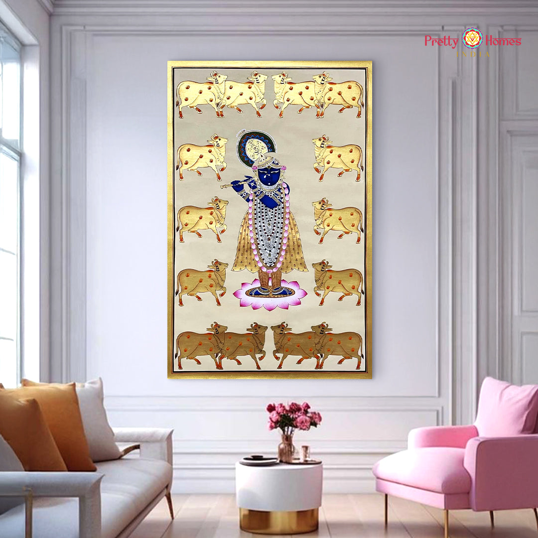 Hand painted Krishna wall art with cows and gold accents framed and staged above sofa