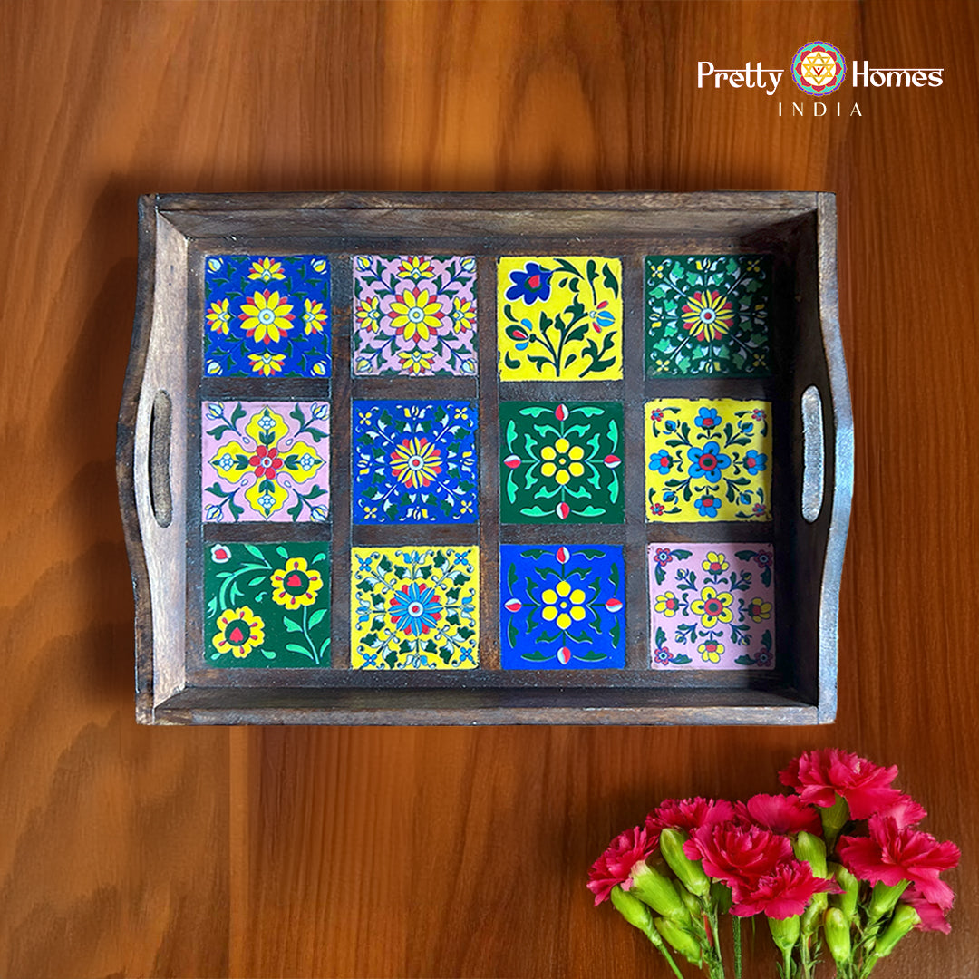Hand-painted wooden serving tray with 12 colourful tile-style floral panels and cutout handles.