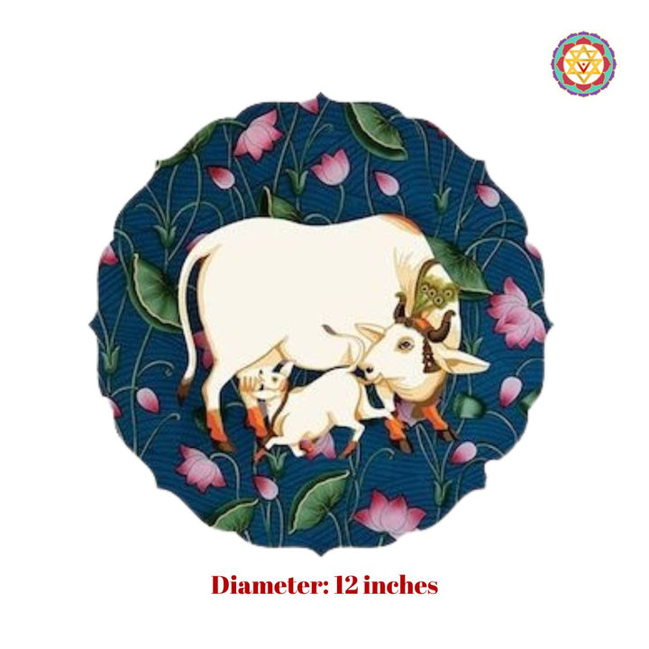 Detailed pichwai wall plate with cow, calf, and pink lotus motifs in a floral silhouette.