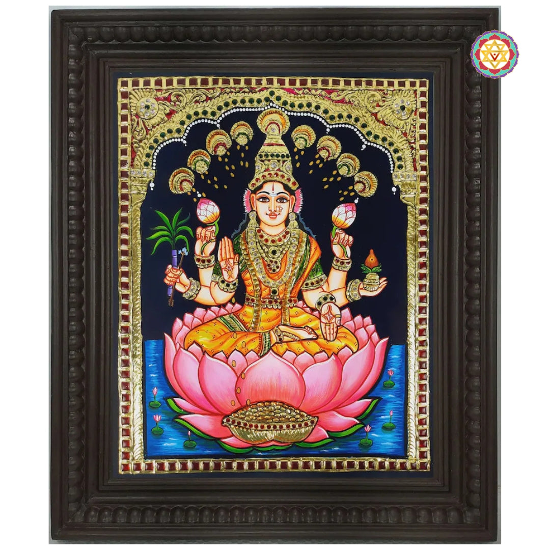 “Goddess Lakshmi Tanjore artwork with gold foil detailing and Chettinad teakwood frame”