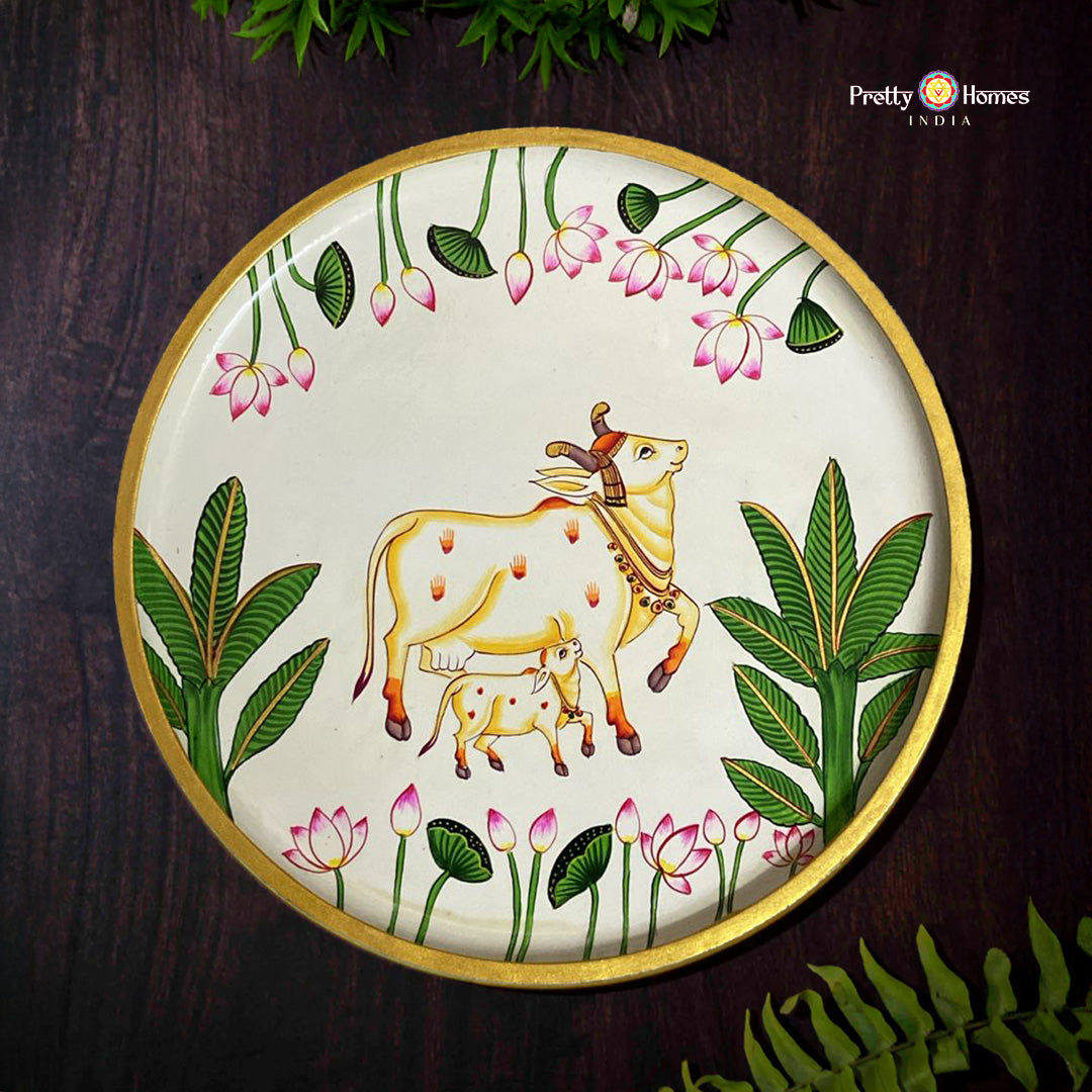 Handpainted wall plate with off white cow and calf surrounded by lotus and leaves