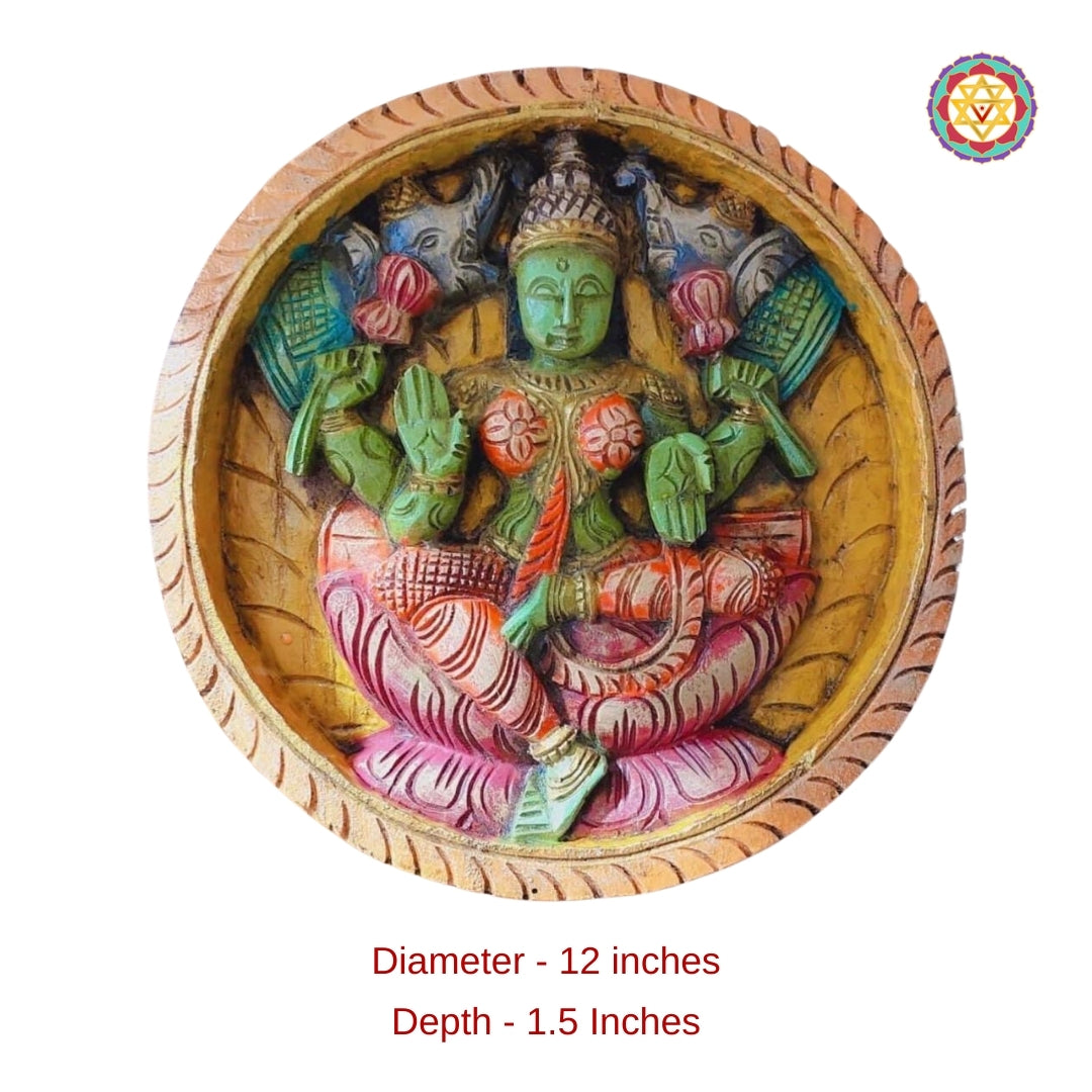 Round wooden panel of Adi Lakshmi seated on lotus with four arms holding lotus flowers, in multicolour finish