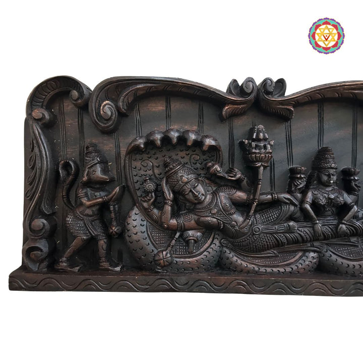 Close-up of reclining Vishnu wood sculpture with serpent Ananta