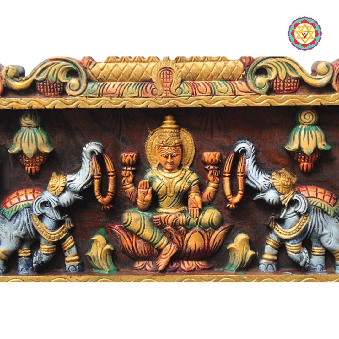 gajalakshmi wooden panel close up showcasing intricate gopuram carving