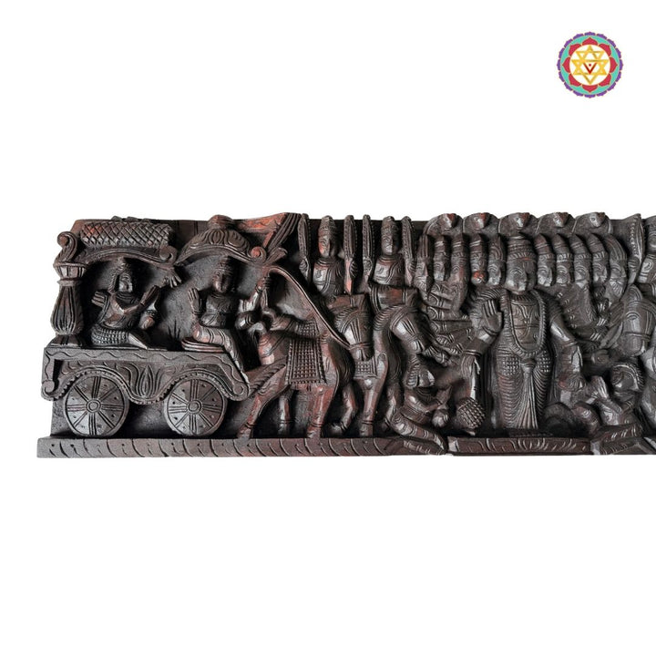 Intricately woodcarved horizontal panel depicting Lord Mahavishnu as Krishna guiding Arjun on a chariot.