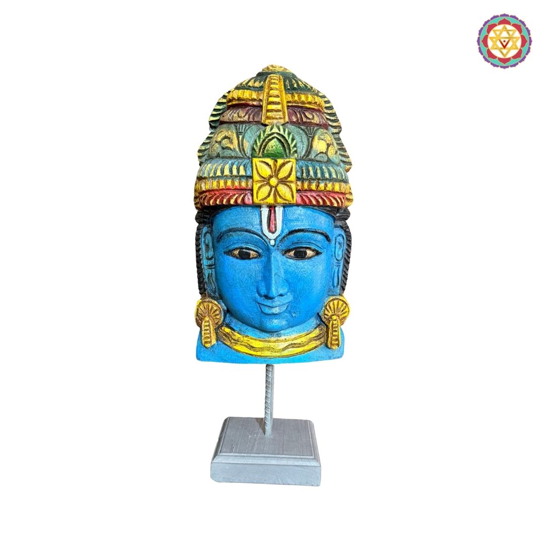 Side angle of Vishnu wooden mask showing carved details and expressions