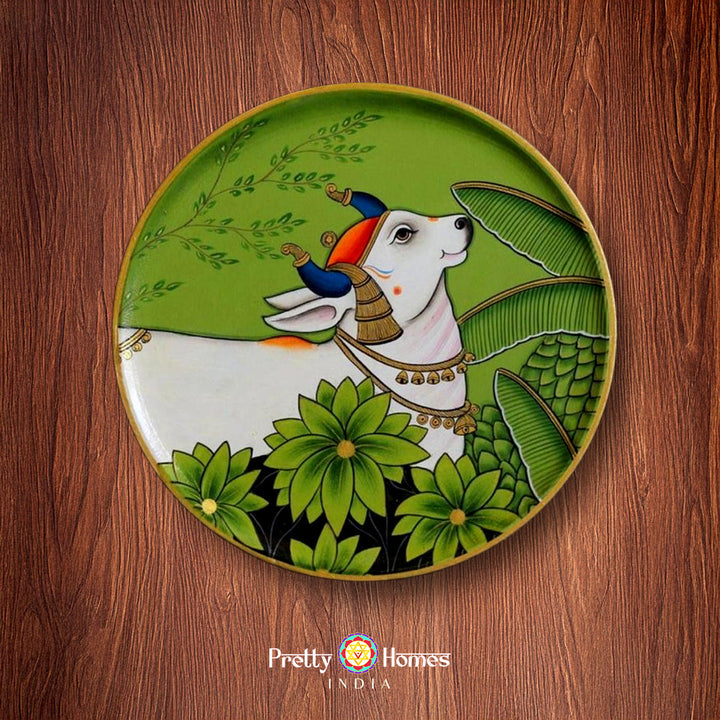 Hand painted wall plate with cow and leaves, pichwai design