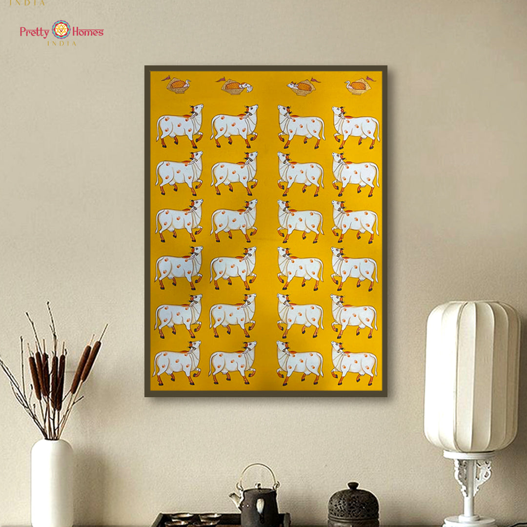 Yellow background pichwai painting with rows of white cows in hand-painted design.