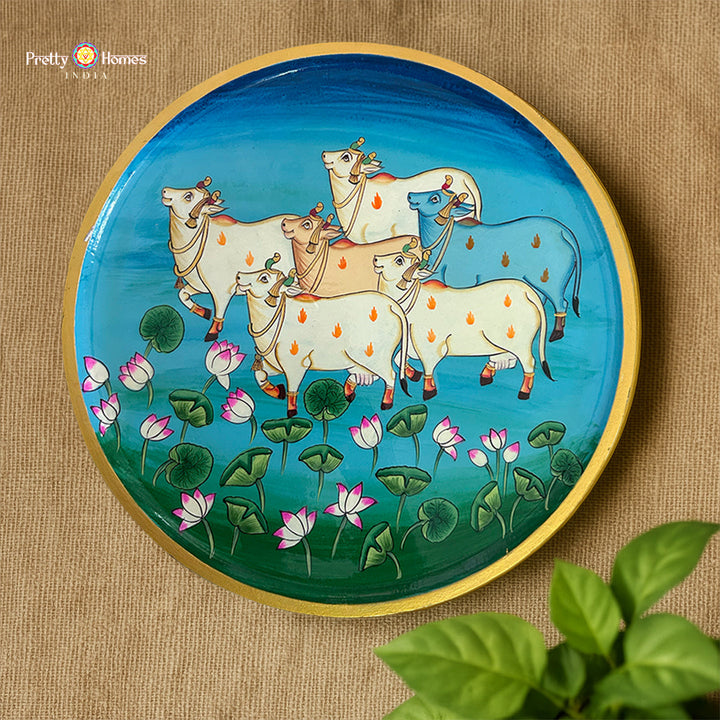 hand-painted Pichwai wall plate featuring cows with lotus motifs