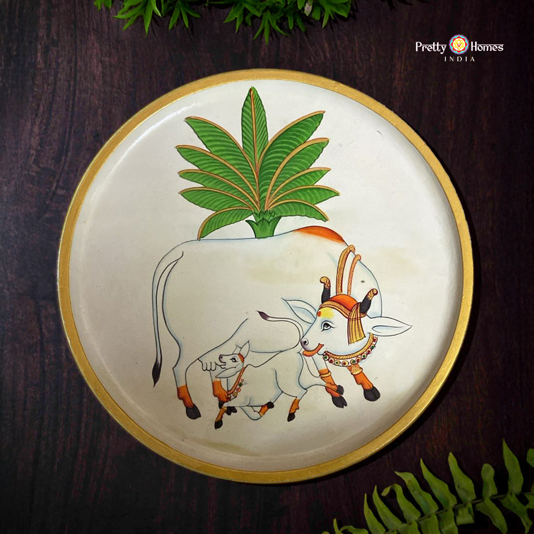 Cow and calf pichwai wall plate in off white with leaf motifs